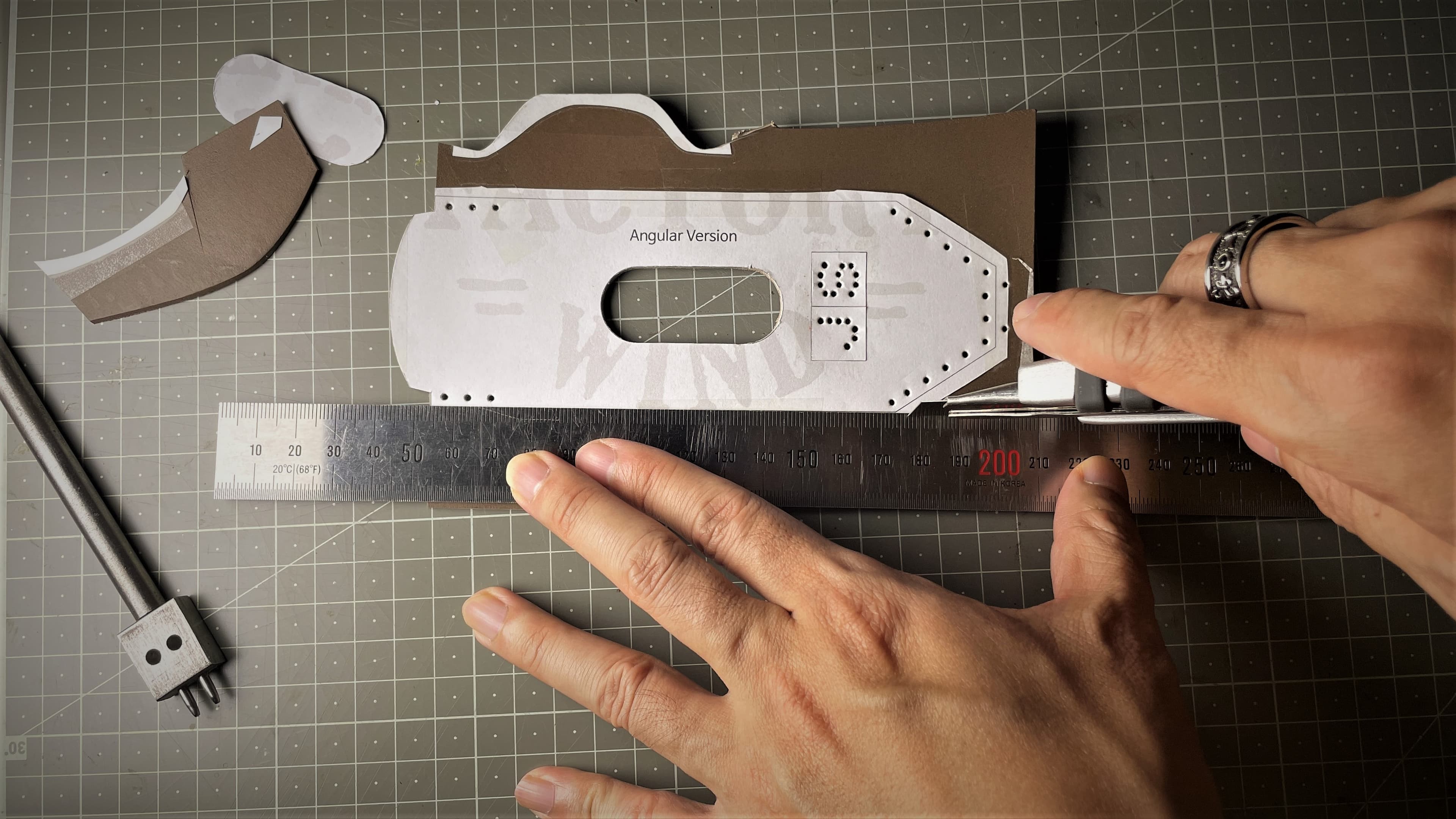 Hand stitching a leather prototype during sample making