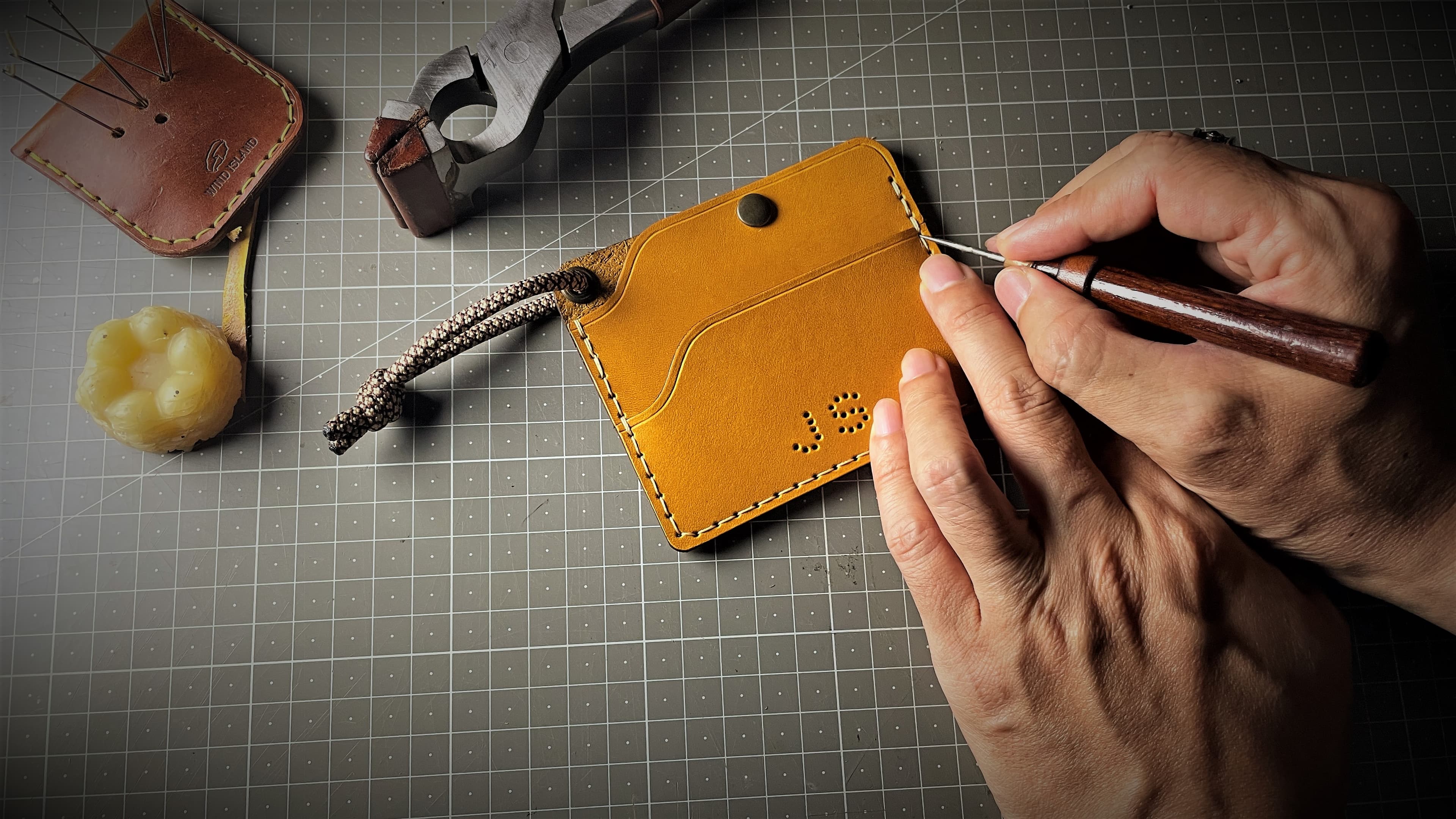 Finishing a handmade leather sample by hand